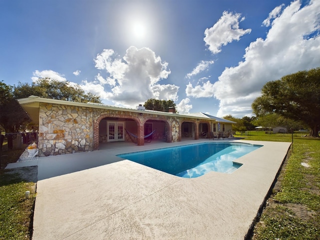 view of pool featuring french doors and a patio area