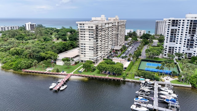 birds eye view of property with a view of city and a water view