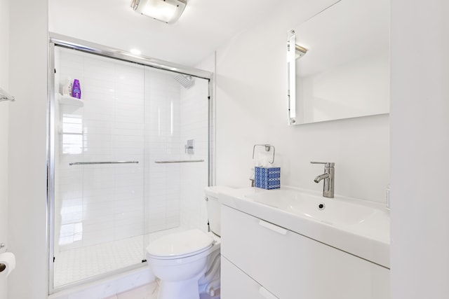 full bathroom with marble finish floor, a shower stall, toilet, and vanity