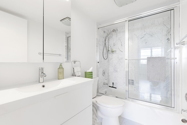 full bathroom with combined bath / shower with glass door, toilet, and vanity