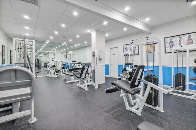 workout area featuring recessed lighting, crown molding, and a paneled ceiling