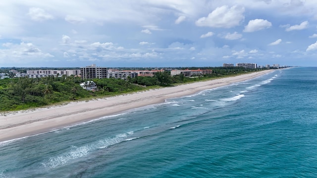 birds eye view of property featuring a view of city, a beach view, and a water view