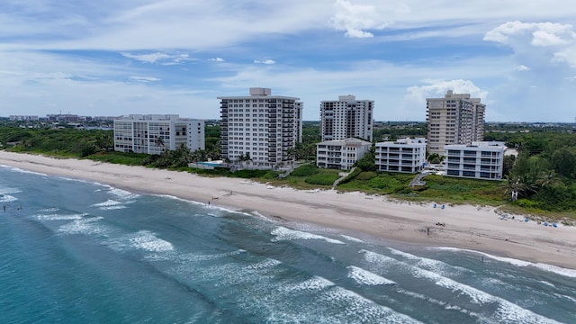 bird's eye view with a water view, a city view, and a view of the beach