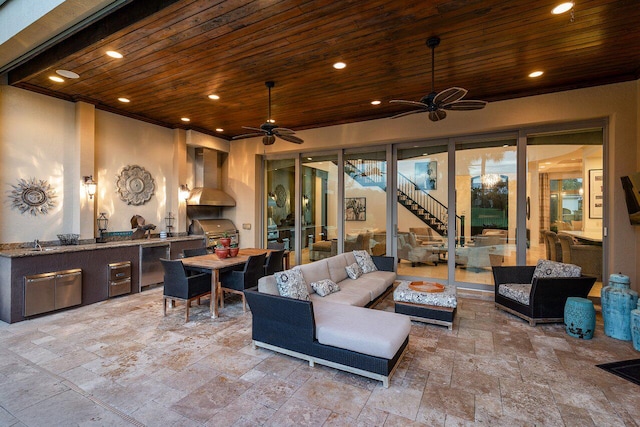 view of patio / terrace with an outdoor hangout area, grilling area, ceiling fan, and exterior kitchen