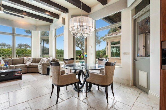 dining room with beam ceiling, a wealth of natural light, and a chandelier