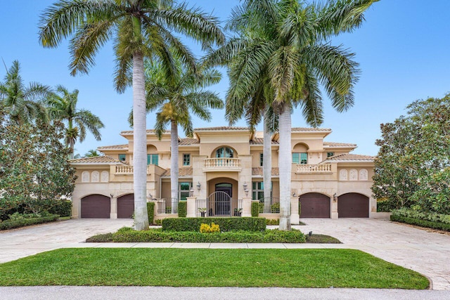 mediterranean / spanish-style home with a garage and a balcony