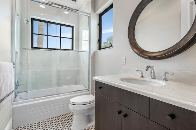 full bathroom with vanity, shower / bath combination with glass door, and toilet