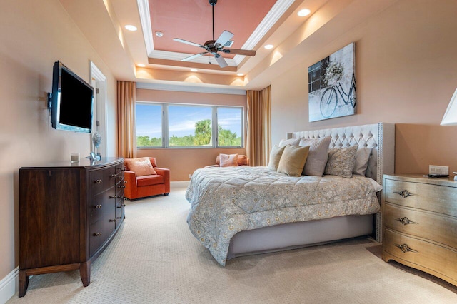 carpeted bedroom with a raised ceiling, crown molding, and ceiling fan