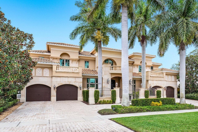 mediterranean / spanish house with a balcony and a garage