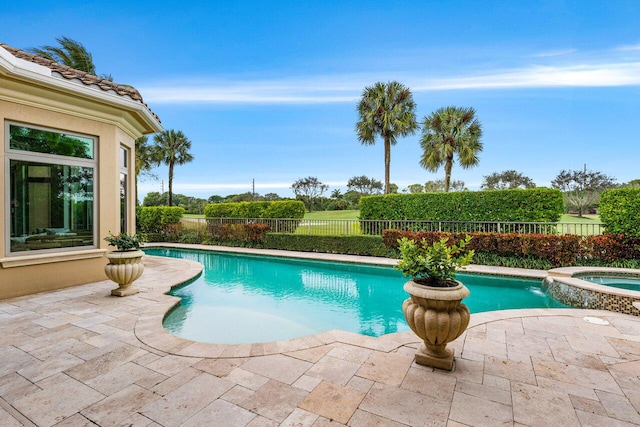 view of swimming pool with an in ground hot tub and a patio area