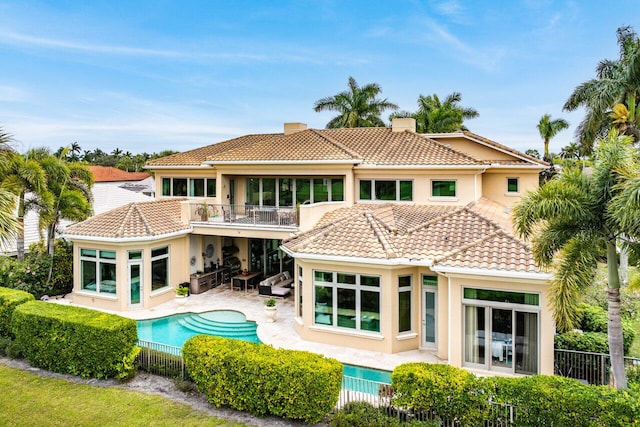 back of house featuring a patio and a balcony