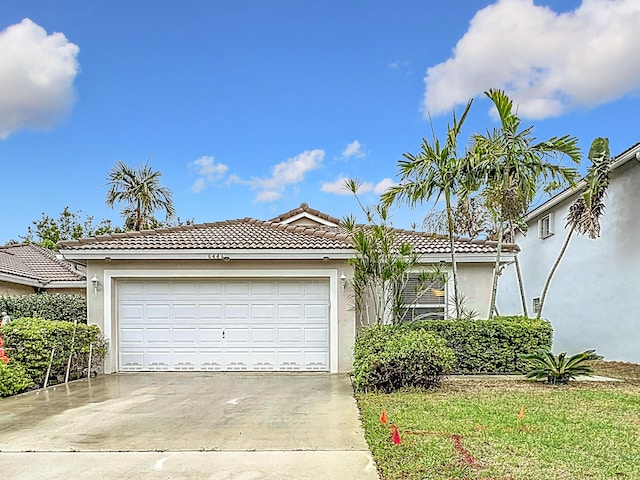 6446 Willoughby Cir, Lake Worth, FL 33463 - view of front facade with concrete driveway, a tiled roof, a garage, and stucco siding