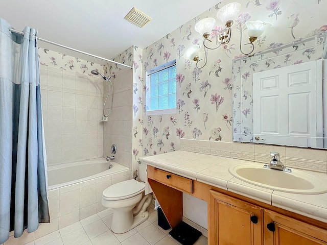 full bathroom with shower / tub combo with curtain, vanity, tile patterned floors, toilet, and a chandelier