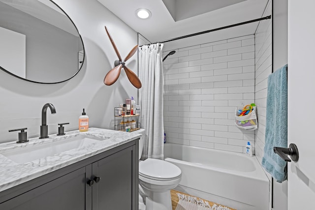 full bathroom featuring vanity, shower / tub combo with curtain, and toilet