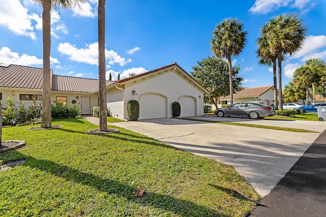 mediterranean / spanish-style house with a garage and a front lawn