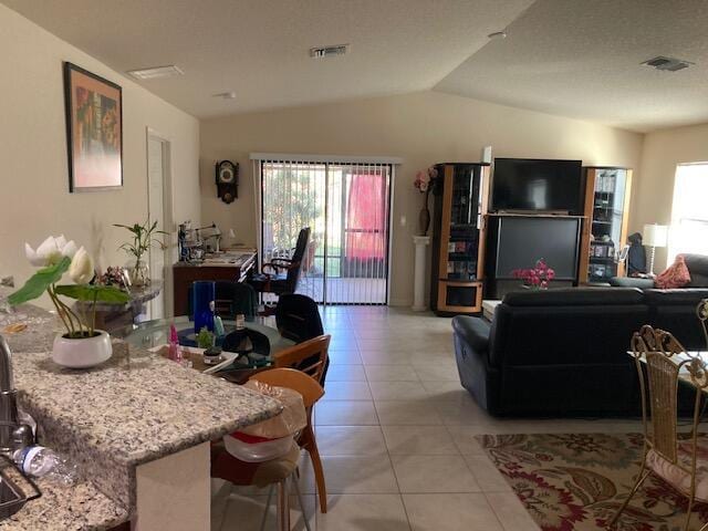 tiled living room featuring lofted ceiling