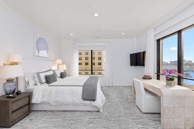 bedroom with ornamental molding and light colored carpet