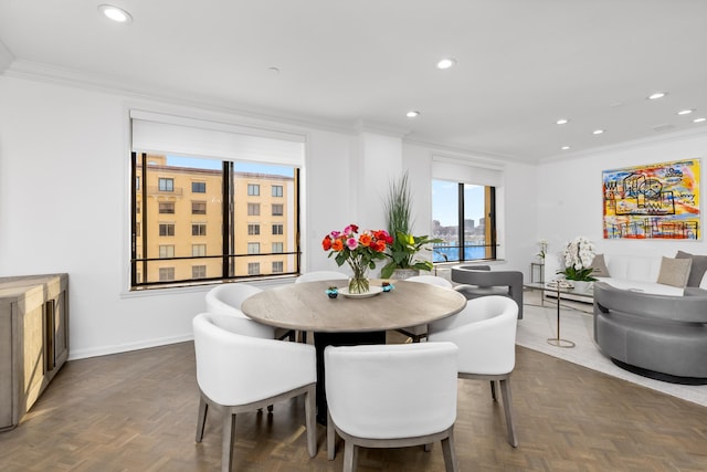 dining space featuring ornamental molding and dark parquet floors