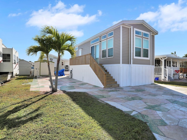 view of side of home featuring a lawn