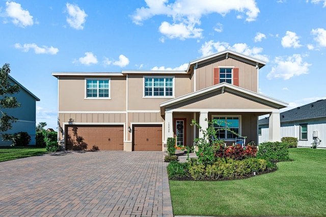 view of front of property featuring a garage and a front lawn