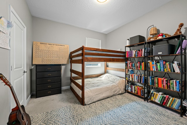 carpeted bedroom featuring a textured ceiling