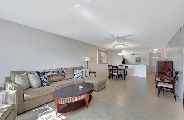 living room featuring ceiling fan and light tile patterned flooring