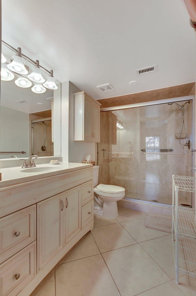 bathroom with walk in shower, vanity, toilet, and tile patterned flooring