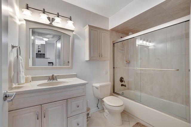 full bathroom featuring bath / shower combo with glass door, vanity, tile patterned floors, and toilet