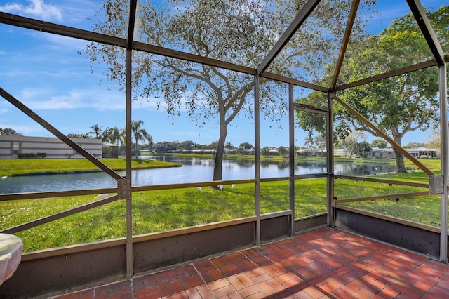 unfurnished sunroom featuring a water view and a healthy amount of sunlight