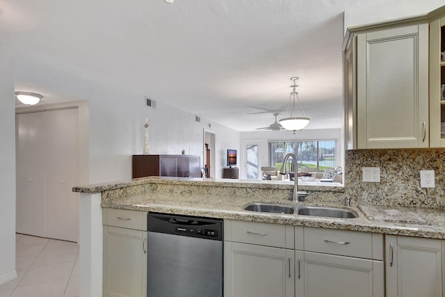 kitchen with sink, light tile patterned floors, stainless steel dishwasher, light stone countertops, and decorative backsplash