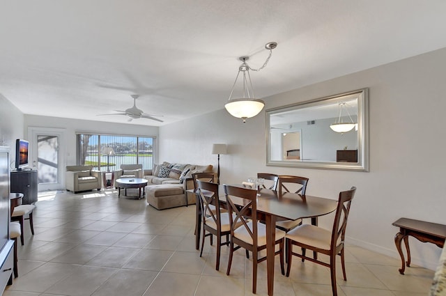 tiled dining space featuring ceiling fan