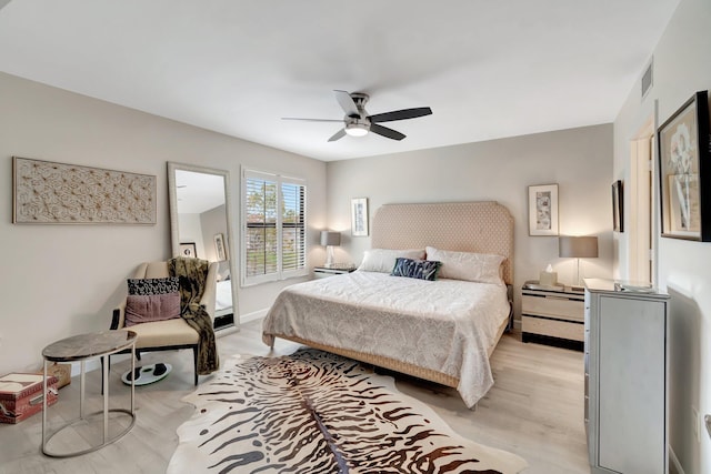 bedroom with ceiling fan and light hardwood / wood-style flooring