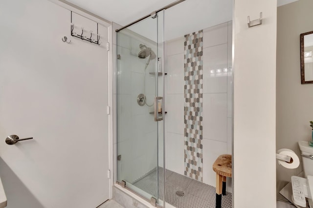 bathroom with a shower with door