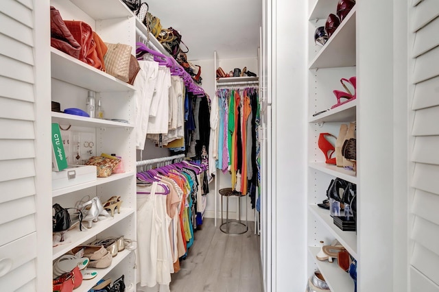 walk in closet featuring light hardwood / wood-style flooring