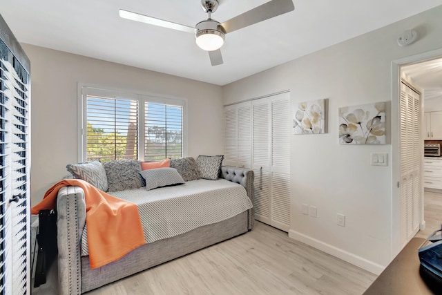 bedroom featuring a closet, ceiling fan, and light wood-type flooring