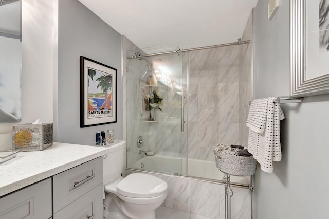 full bathroom with toilet, vanity, and bath / shower combo with glass door