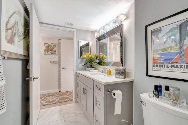 bathroom featuring vanity and toilet