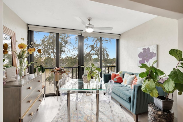 sunroom featuring a healthy amount of sunlight and ceiling fan