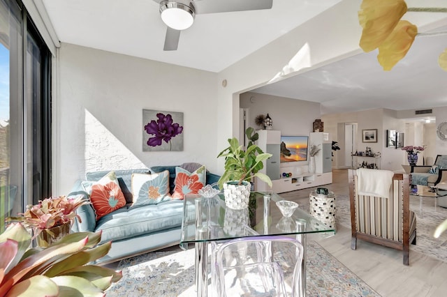 living room with ceiling fan and light wood-type flooring