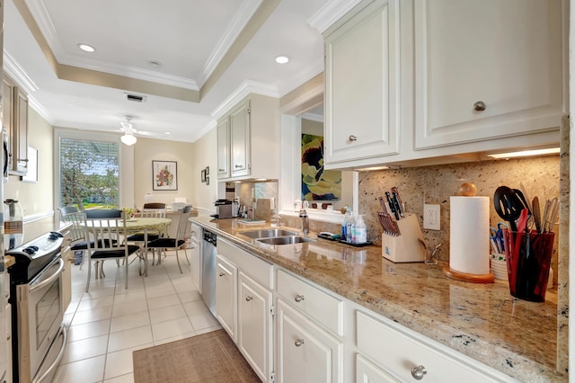 kitchen featuring sink, white cabinetry, stainless steel appliances, light tile patterned flooring, and a raised ceiling