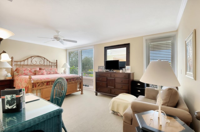 carpeted bedroom with crown molding and ceiling fan