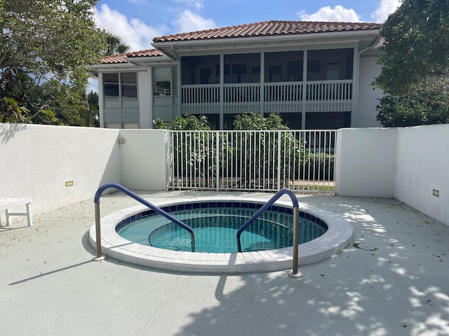 view of swimming pool featuring an in ground hot tub and a patio area