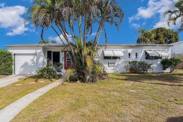 view of front of home featuring a garage and a front lawn