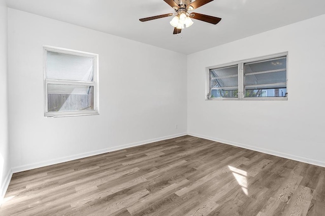 empty room with hardwood / wood-style flooring and ceiling fan