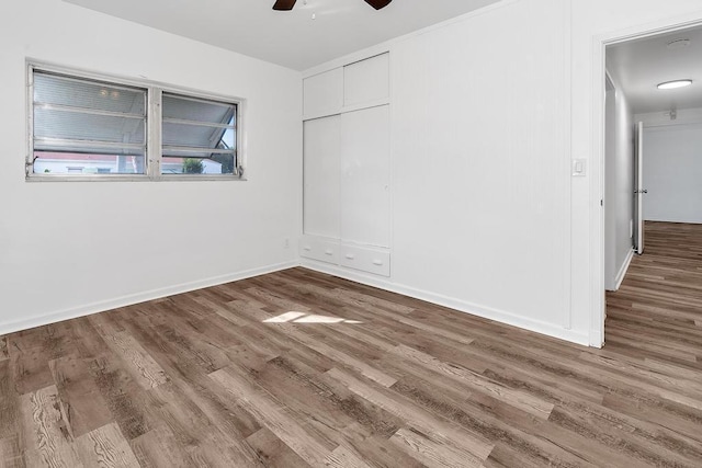 unfurnished room with hardwood / wood-style floors and ceiling fan