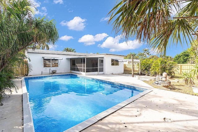 view of swimming pool with a patio and a sunroom