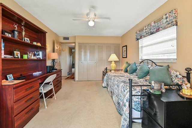 bedroom featuring ceiling fan, a closet, and light carpet