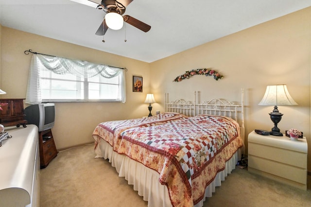 bedroom featuring light carpet and ceiling fan