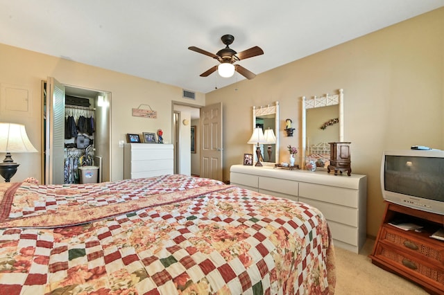 carpeted bedroom featuring ceiling fan and a closet