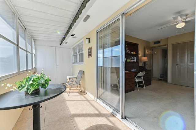 sunroom featuring rail lighting